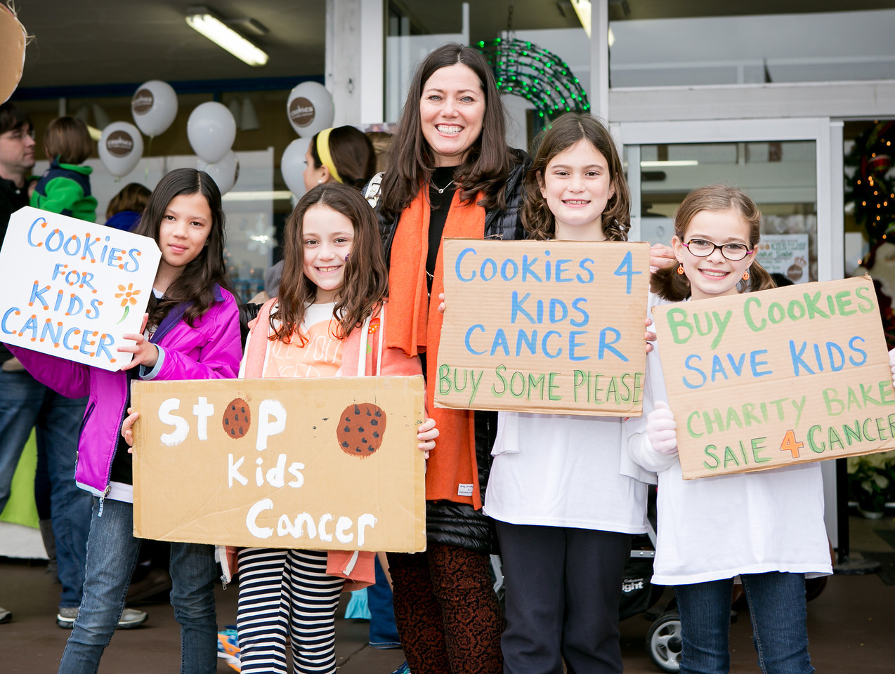 Gretchen and kids with signs
